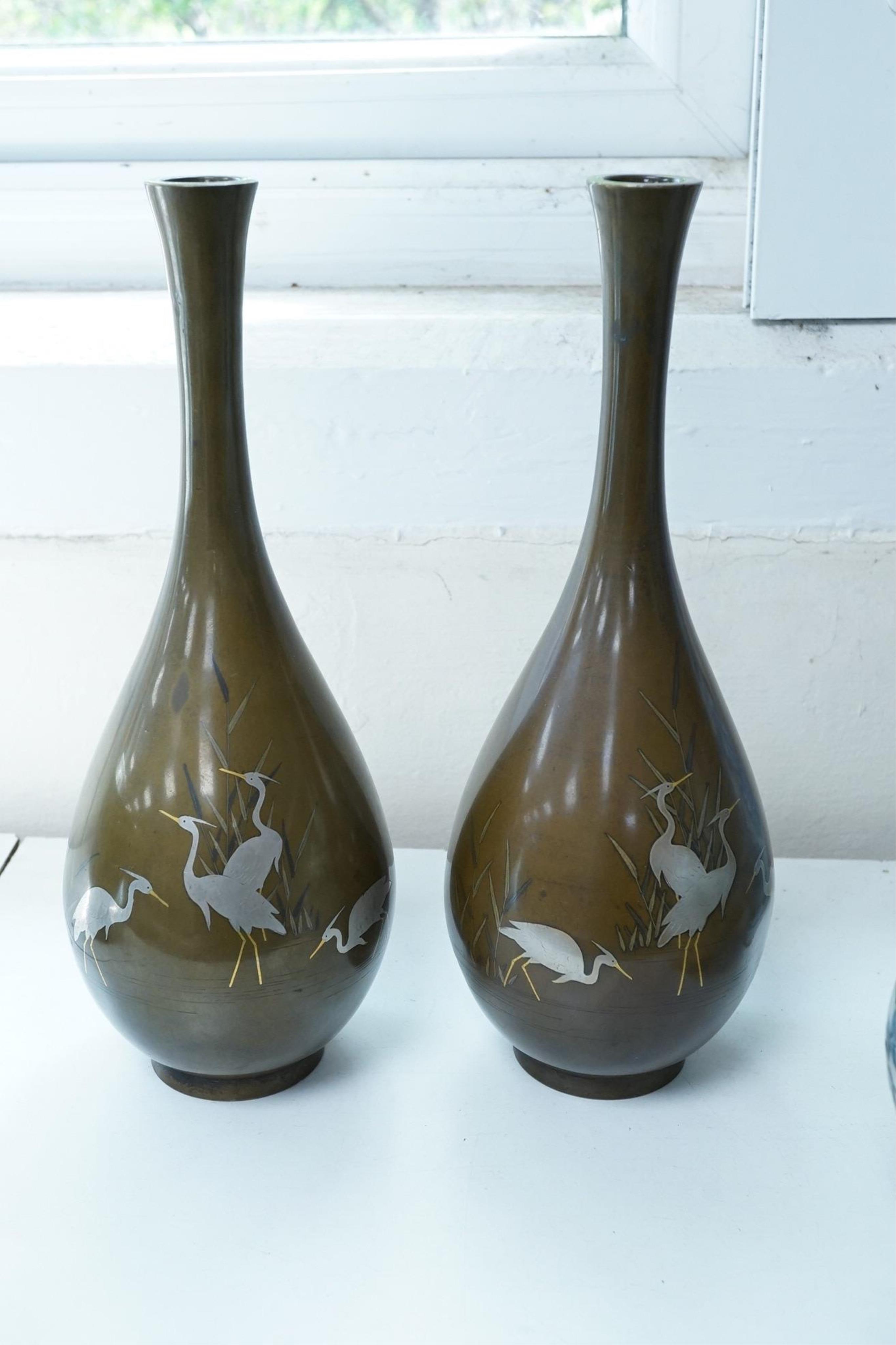 A pair of Japanese bronze and mixed metal inlaid bottle vases, signed Hidemitsu, Meiji period